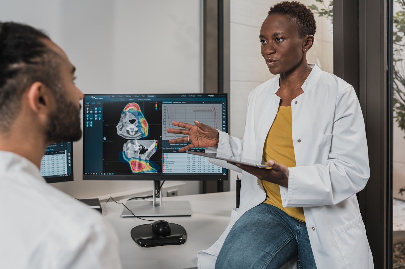 Two clinicians reviewing a diagnostic scan on-site at the clinic
